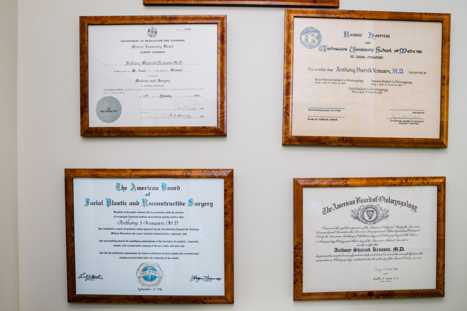 A wall with several different certificates hanging on it.