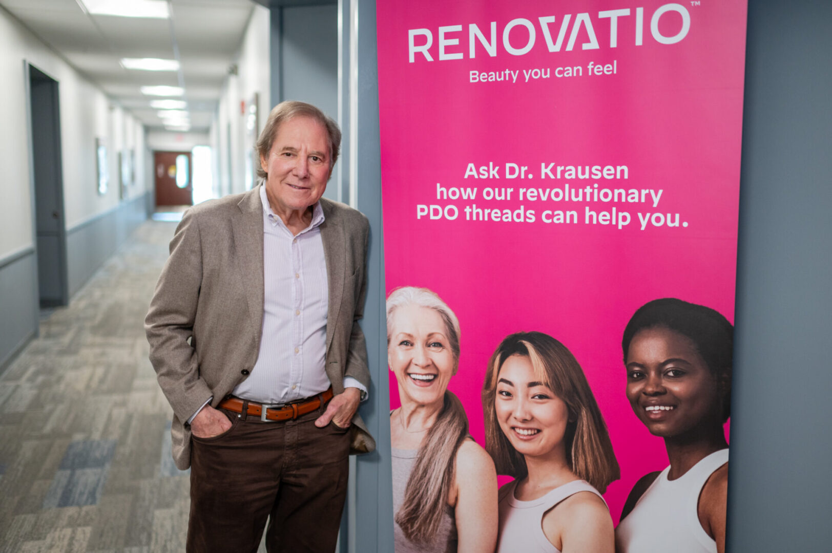 A man standing in front of a renovation banner.