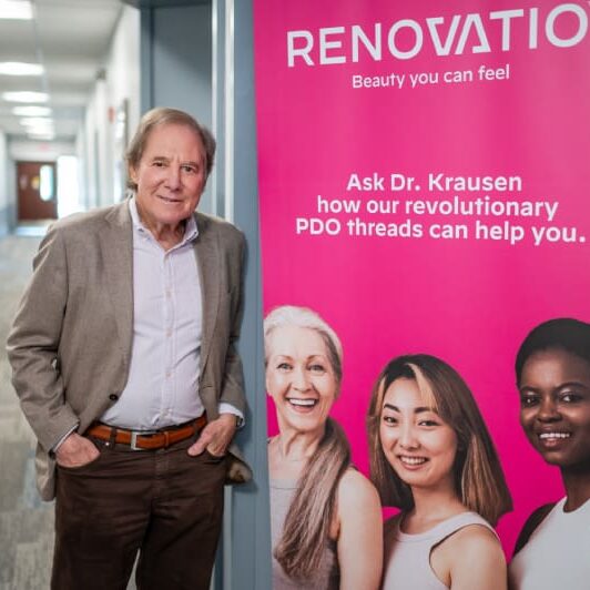 A man standing in front of a renovation banner.